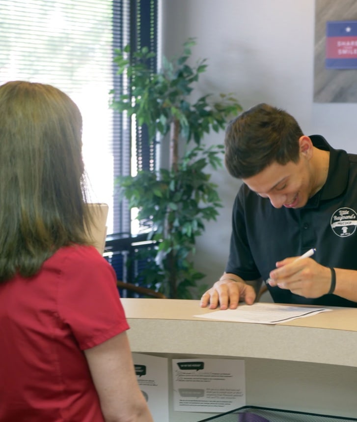 patient smiling and filling out paperwork
